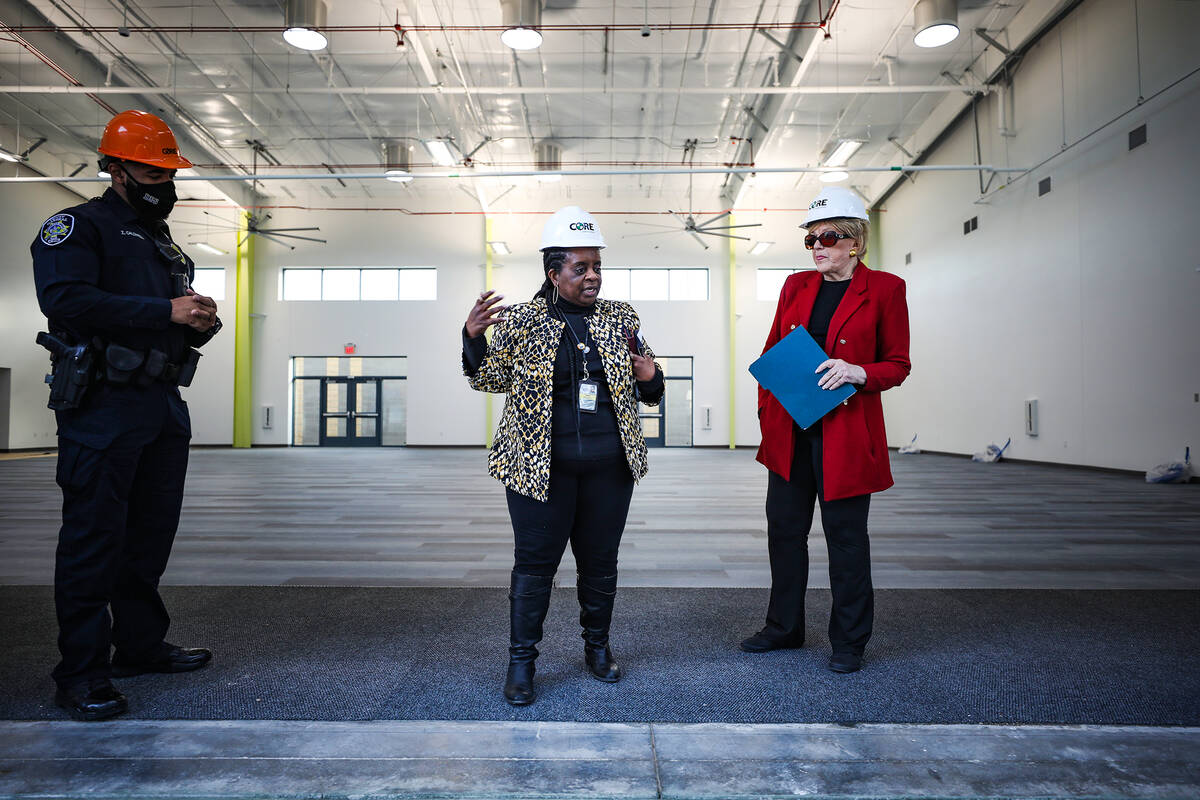 Kathi Thomas, director of community services for the city of Las Vegas, left, leads a tour for ...