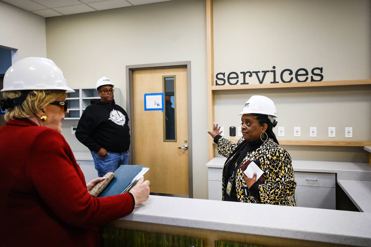 Kathi Thomas, director of community services for the city of Las Vegas, right, leads a tour for ...