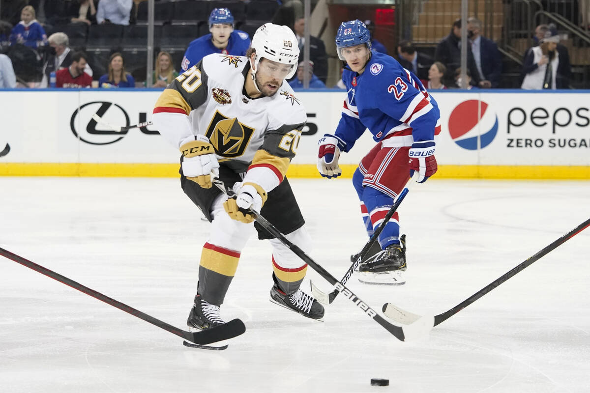 Vegas Golden Knights center Chandler Stephenson (20) controls the puck ahead of New York Ranger ...