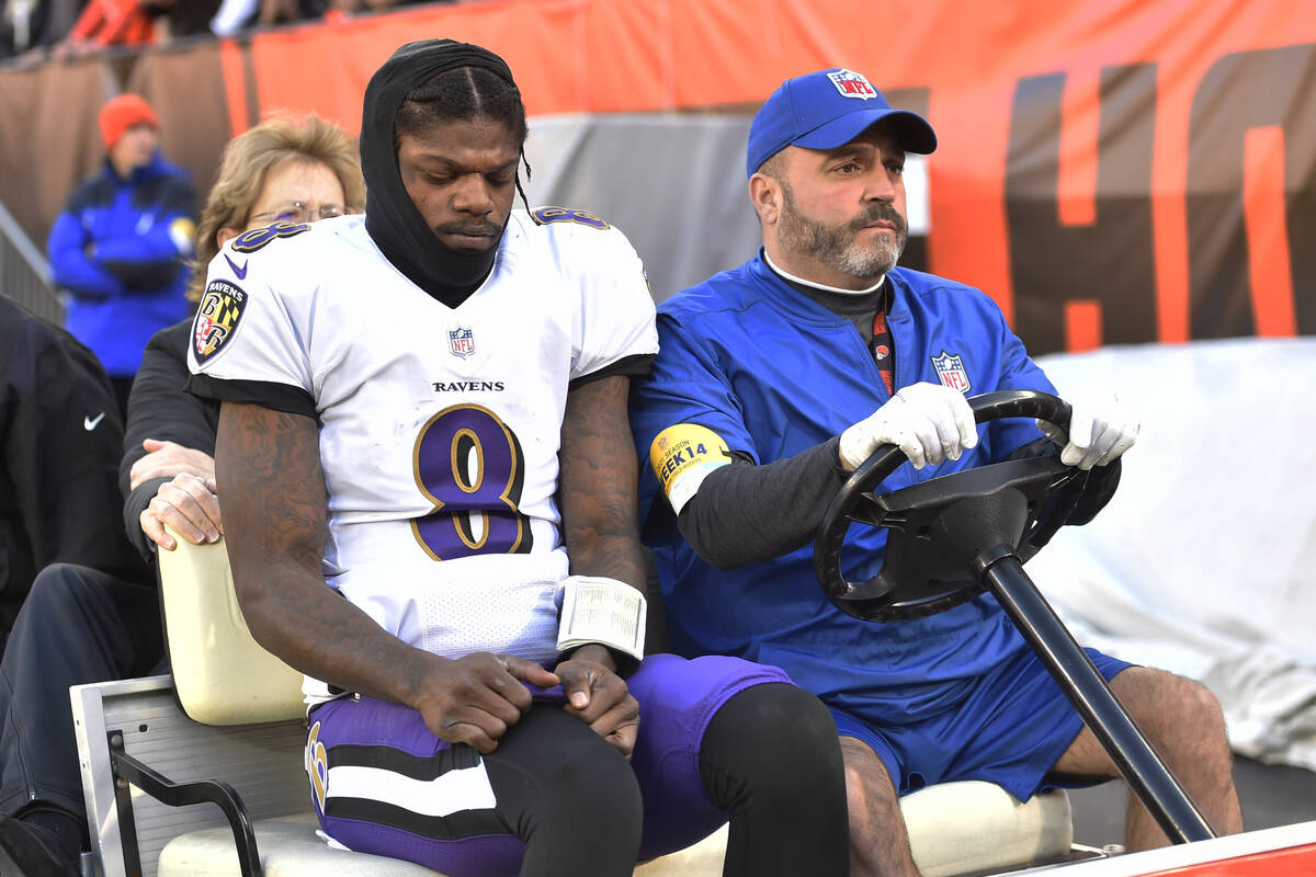 Baltimore Ravens quarterback Lamar Jackson (8) is carted off the field after an injury during t ...