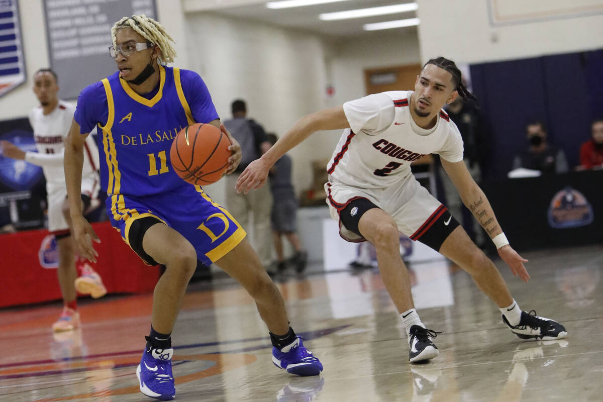 De La Salle's Evan Jackson (11) keeps a ball away from Coronado's Richard "PopPop" Is ...