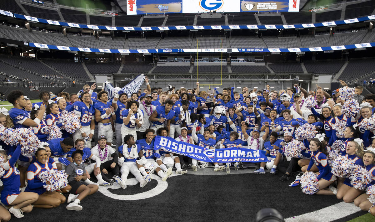Bishop Gorman players, coaches and others come together on the field after beating McQueen in t ...