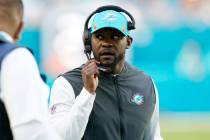 Miami Dolphins head coach Brian Flores talks on the sidelines during the first half of an NFL f ...