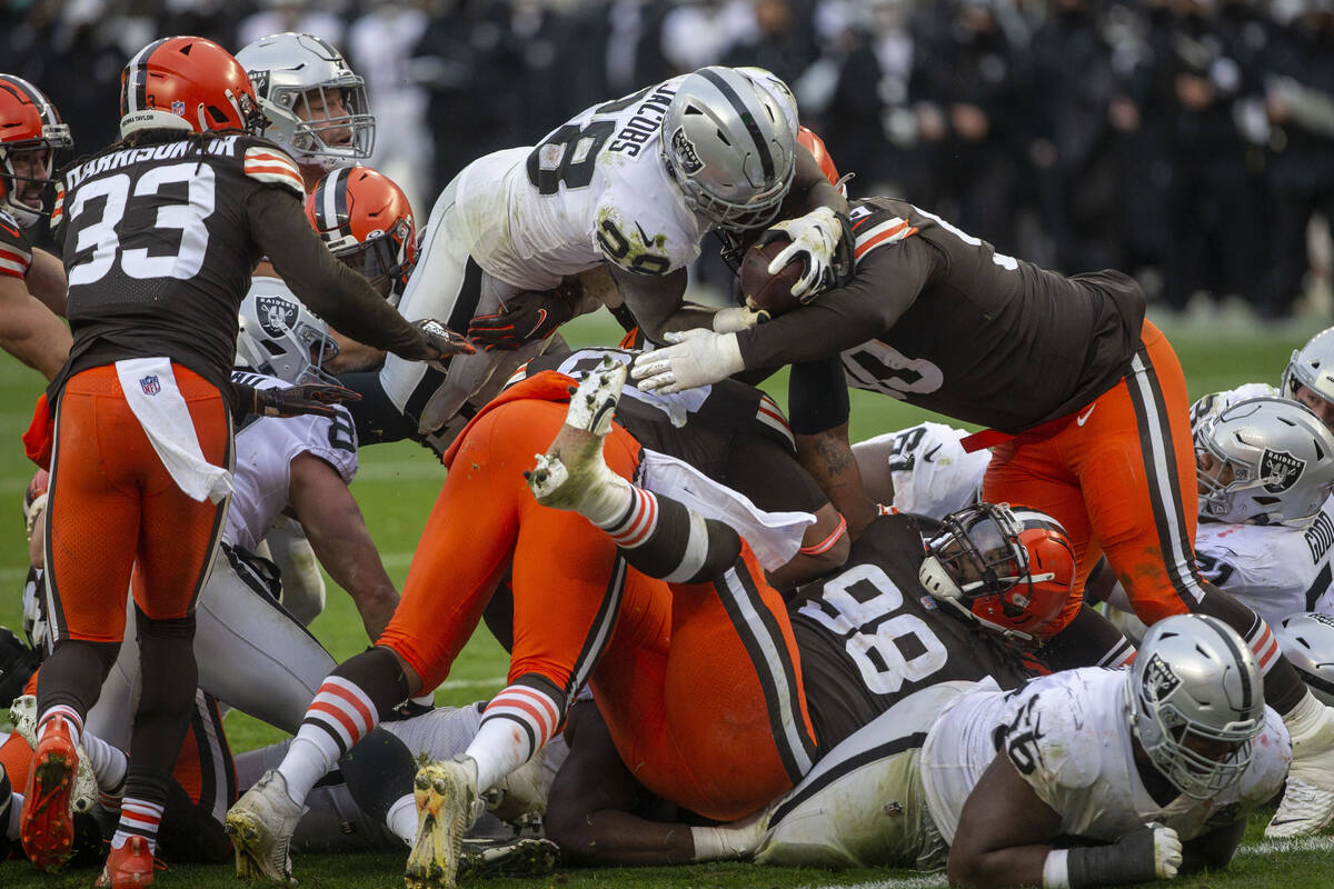 Las Vegas Raiders moving  backmost  Josh Jacobs (28) leaps implicit    against the Cleveland Browns defende ...