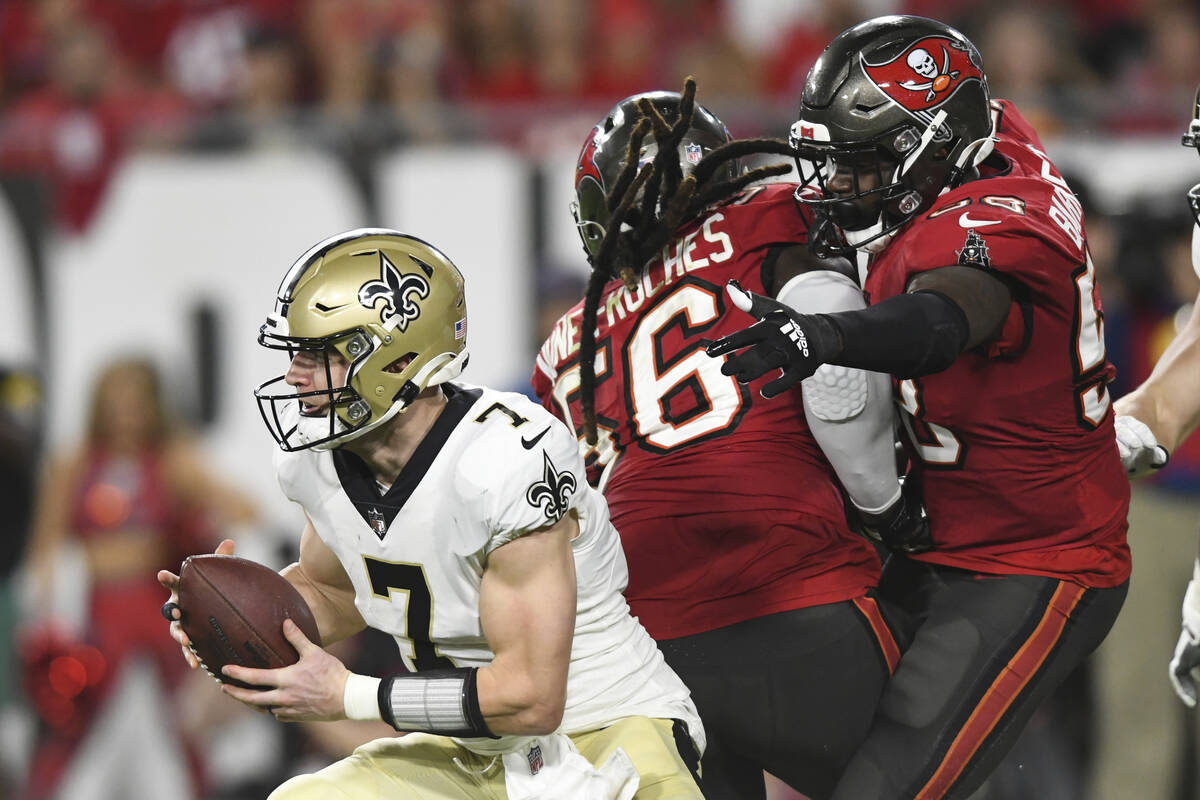New Orleans Saints quarterback Taysom Hill (7) eludes Tampa Bay Buccaneers defensive tackle Rak ...