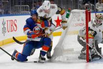 New York Islanders' Zach Parise (11) and Vegas Golden Knights' Zach Whitecloud (2) battle for t ...