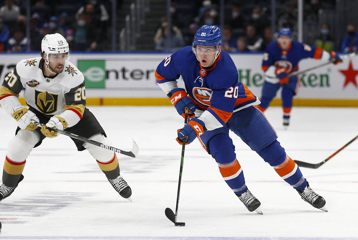 New York Islanders' Kieffer Bellows (20) skates with the puck past Vegas Golden Knights' Chandl ...