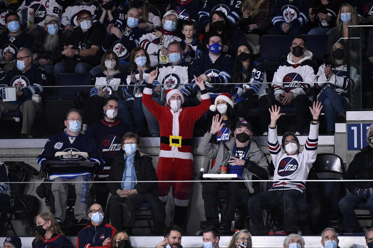 Winnipeg Jets fans cheer during the second period of NHL hockey game action against the St. Lou ...