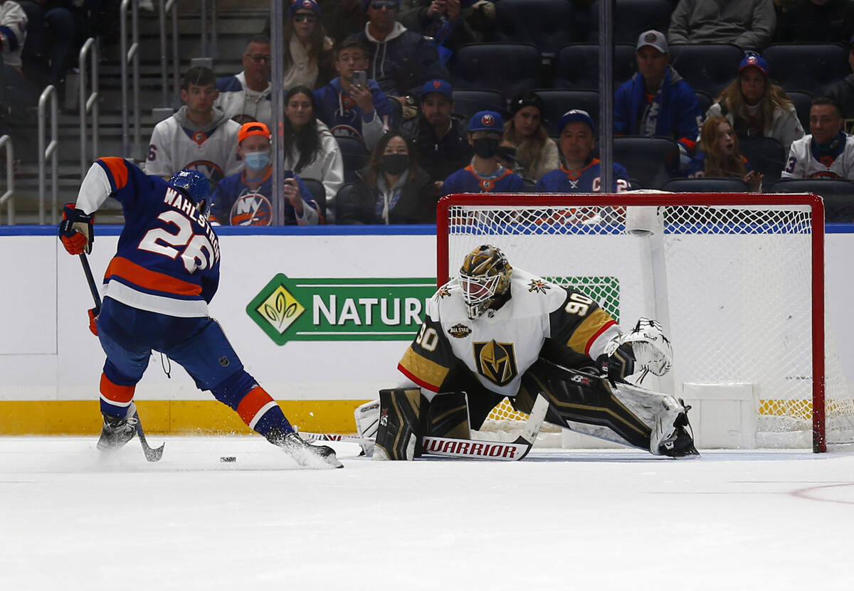 Vegas Golden Knights' Robin Lehner, right, makes a save against New York Islanders' Oliver Wahl ...