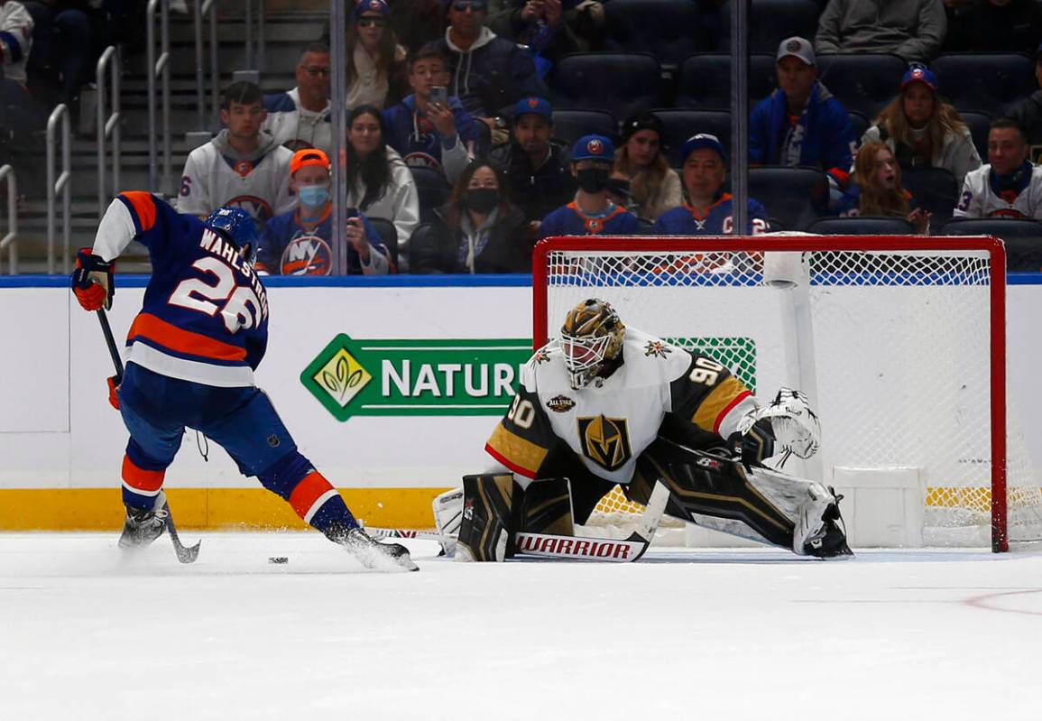 Vegas Golden Knights' Robin Lehner, right, makes a save against New York Islanders' Oliver Wahl ...
