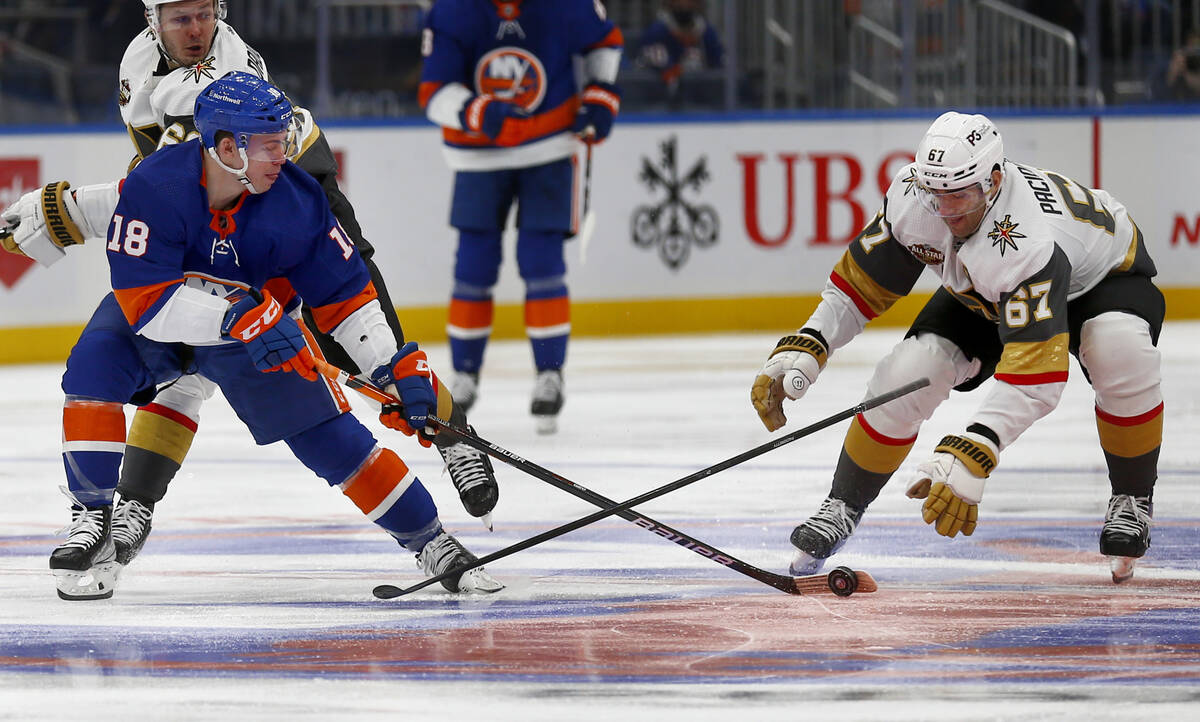 New York Islanders' Anthony Beauvillier (18) reaches for the puck as Vegas Golden Knights' Max ...