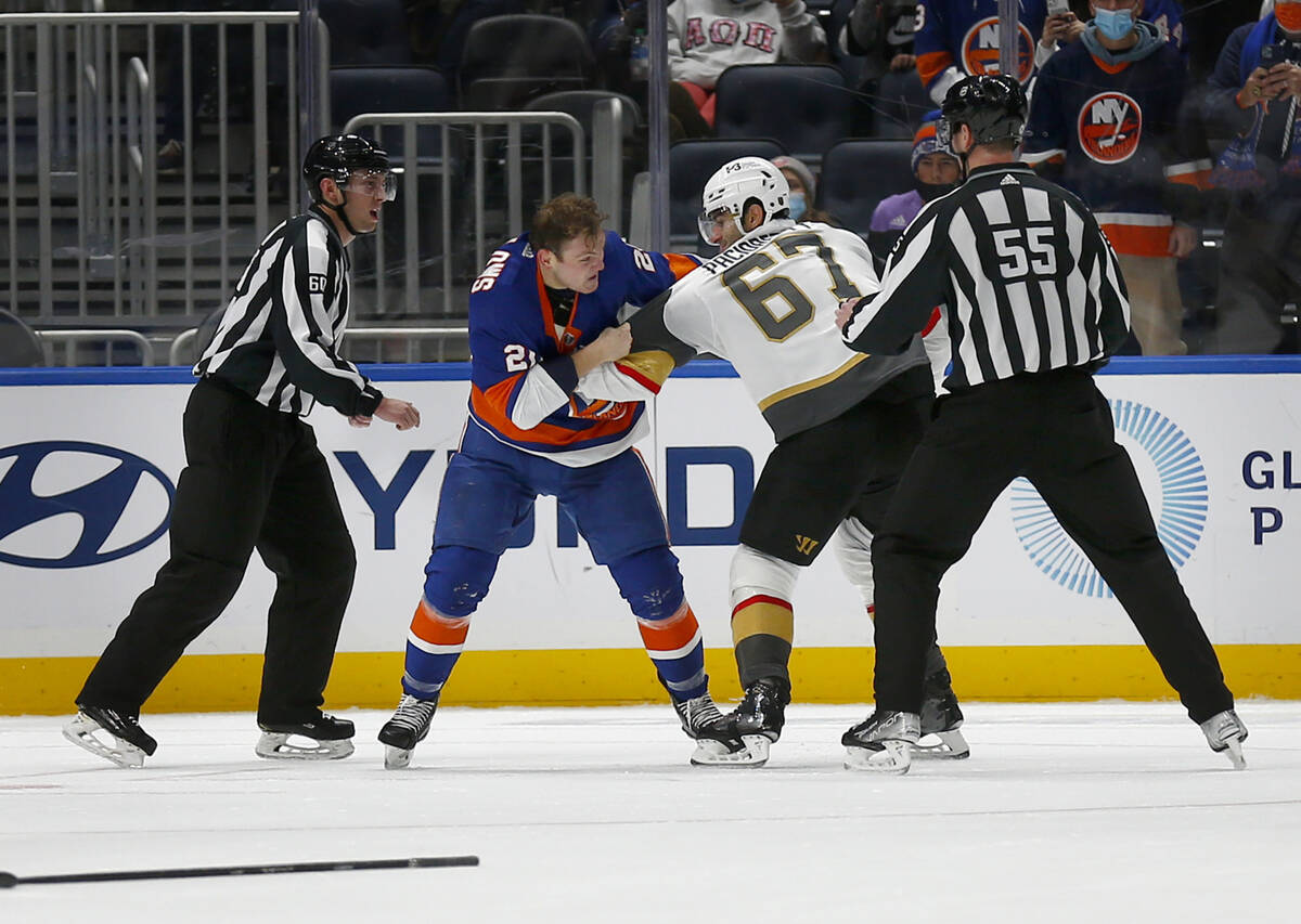 New York Islanders' Kieffer Bellows (20) and Vegas Golden Knights' Max Pacioretty (67) fight du ...