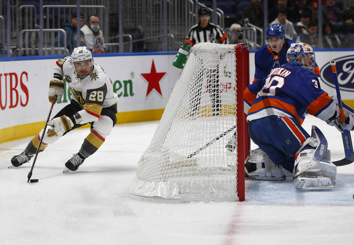 Vegas Golden Knights' William Carrier (28) skates with the puck as New York Islanders' Ilya Sor ...