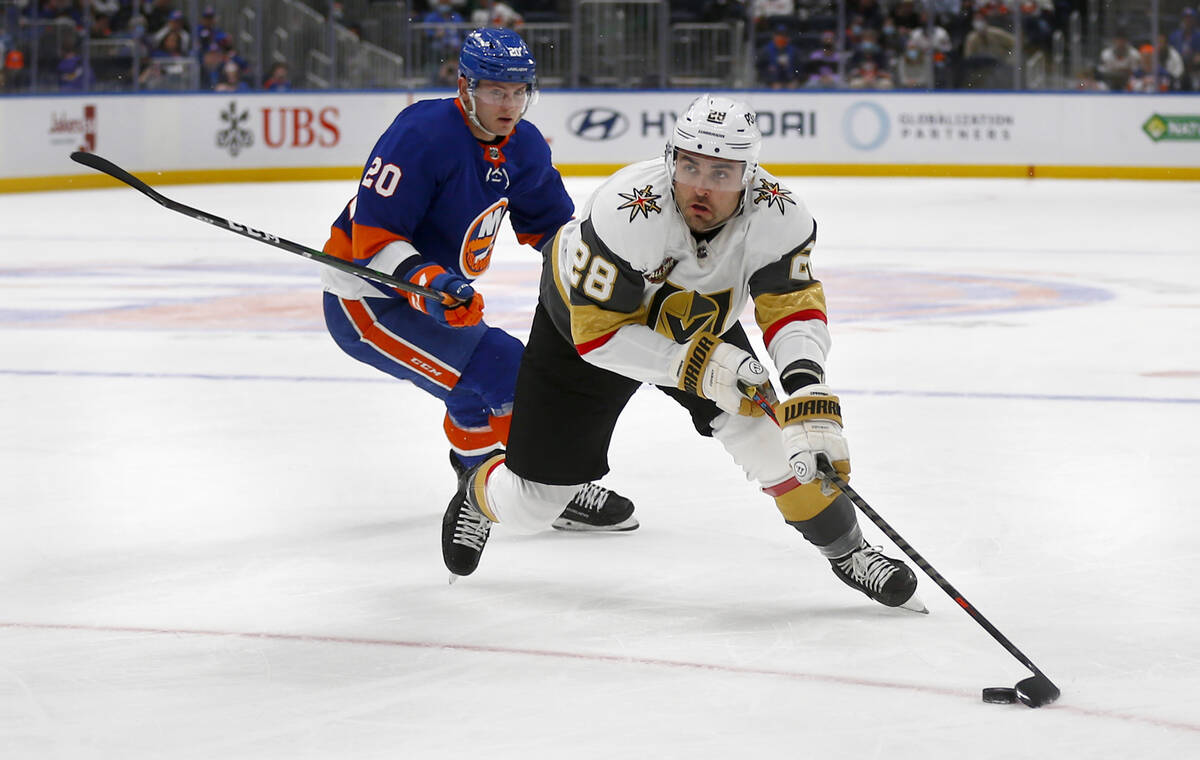 New York Islanders' Kieffer Bellows (20) defends against Vegas Golden Knights' William Carrier ...