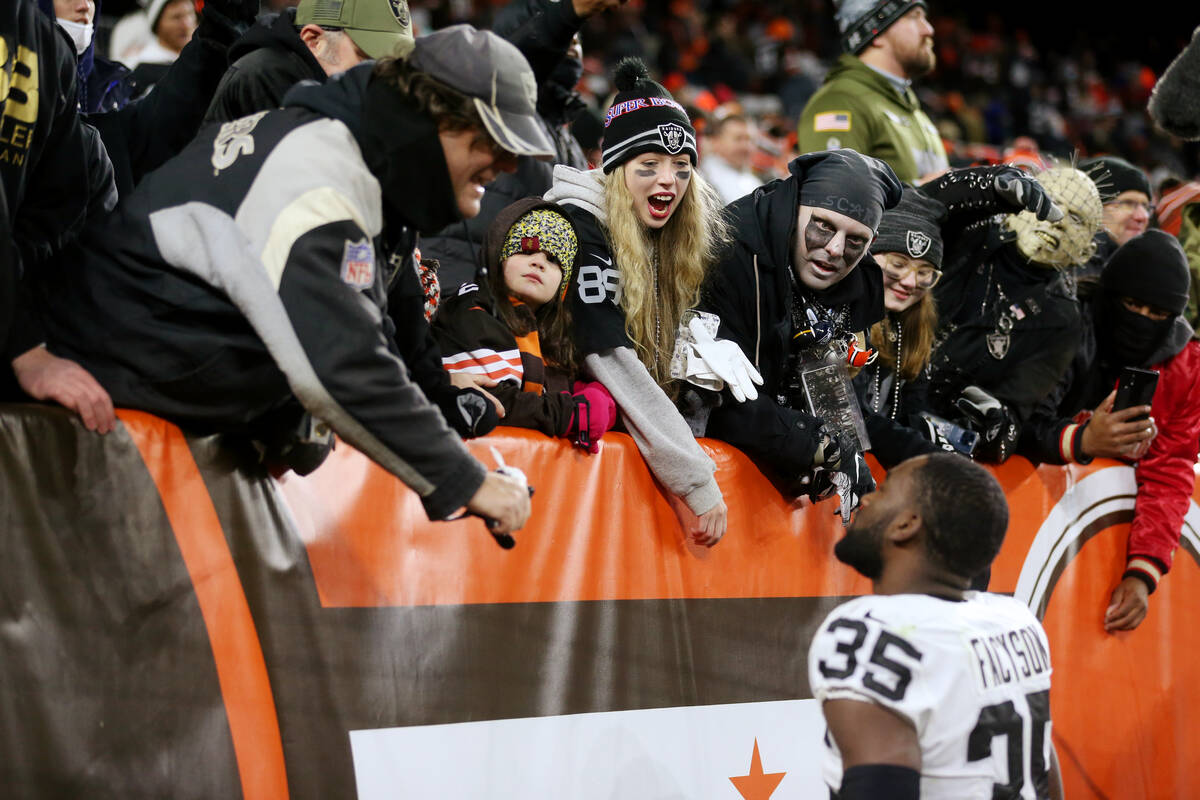 Fans celebrate the Raiders victory with cornerback Brandon Facyson (35) after an NFL football g ...