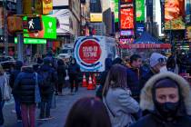 People wait in a long line to get tested for COVID-19 in Times Square, New York, Monday, Dec. 2 ...