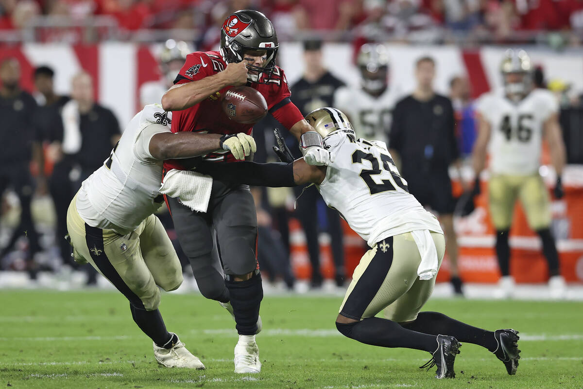 Tampa Bay Buccaneers quarterback Tom Brady (12) fumbles the football after getting hit by New O ...