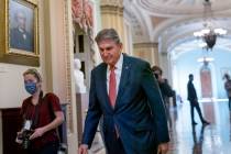 FILE - Sen. Joe Manchin, D-W.Va., walks to a caucus lunch at the Capitol in Washington, Dec. 17 ...