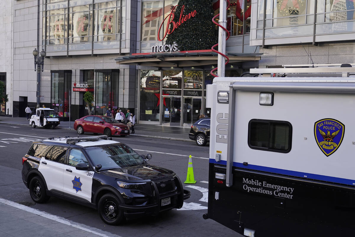 FILE - Police vehicles are stationed at Union Square following recent robberies in San Francisc ...