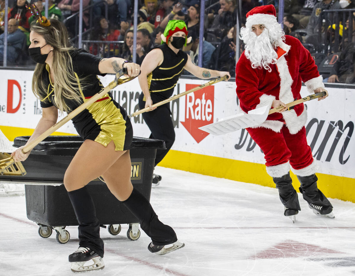 The Golden Knights ice crew dresses in holiday attire during an NHL hockey game against the Tam ...