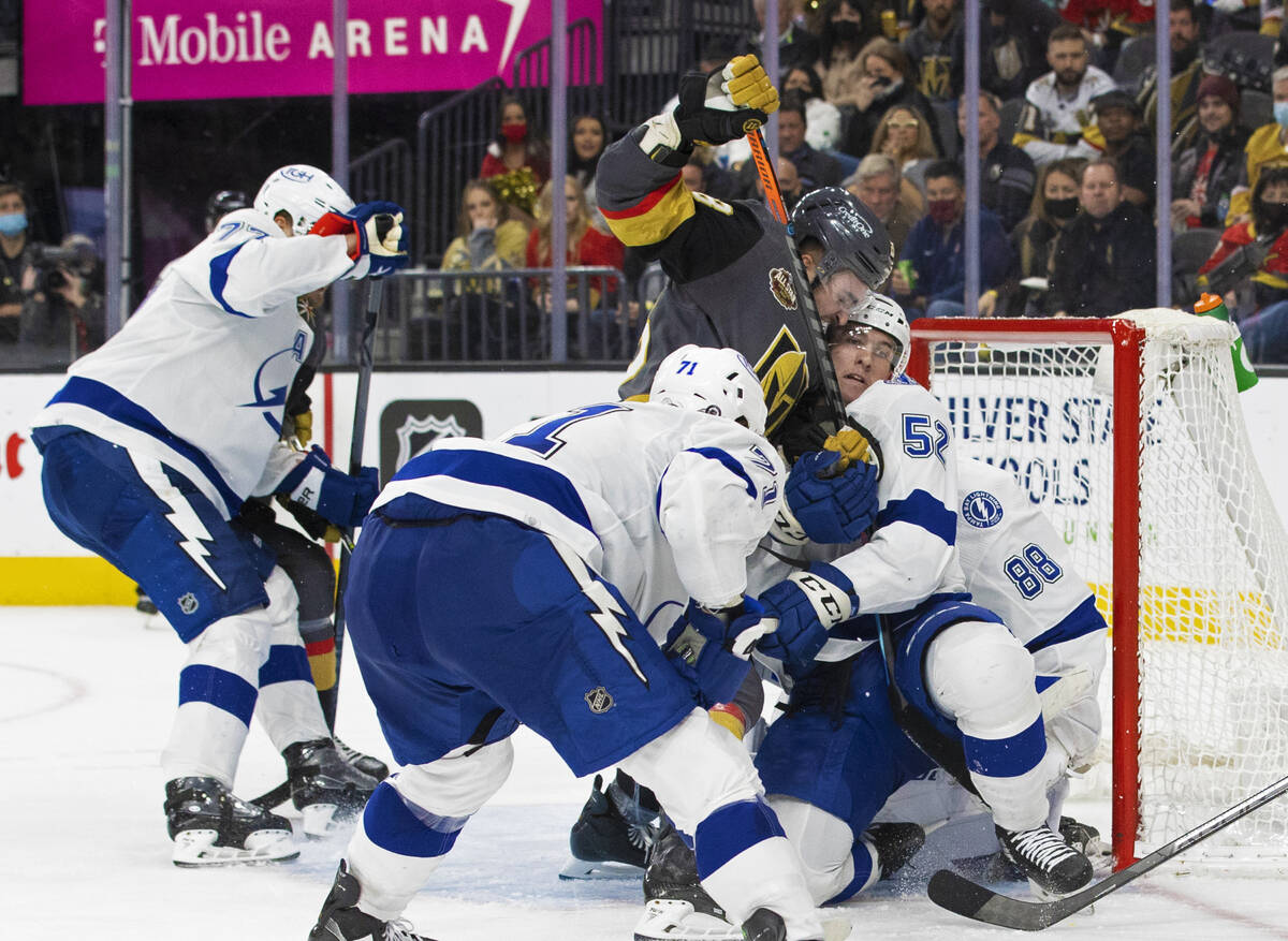 Vegas Golden Knights left wing William Carrier (28) collides with Tampa Bay Lightning defensema ...