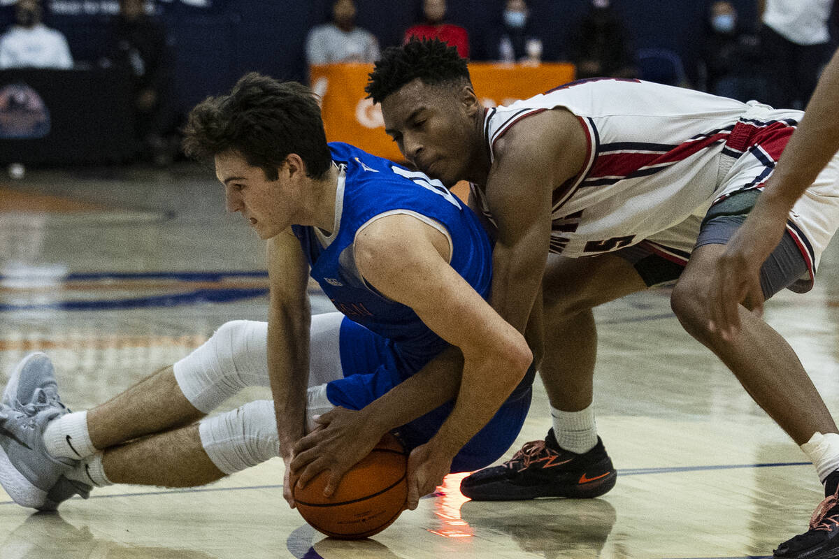Bishop GormanÕs Ryan Abelman (0) and Liberty High Aaron Price Jr. (15) fight for the loose ...