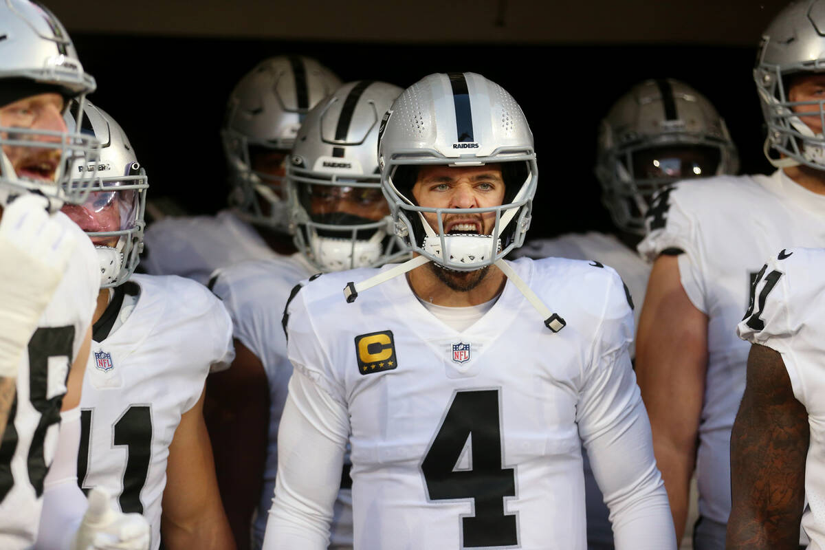 Raiders quarterback Derek Carr (4) gets ready to take the field with his team for the start of ...