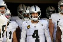 Raiders quarterback Derek Carr (4) gets ready to take the field with his team for the start of ...