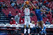 UNLV Rebels guard Bryce Hamilton (13) sets up for a three-point basket over San Diego Toreros g ...