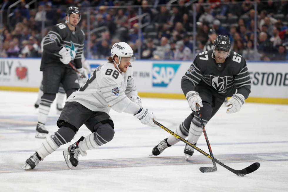 Boston Bruins forward David Pastrnak (88) battles for the puck with Golden Knights forward Max ...
