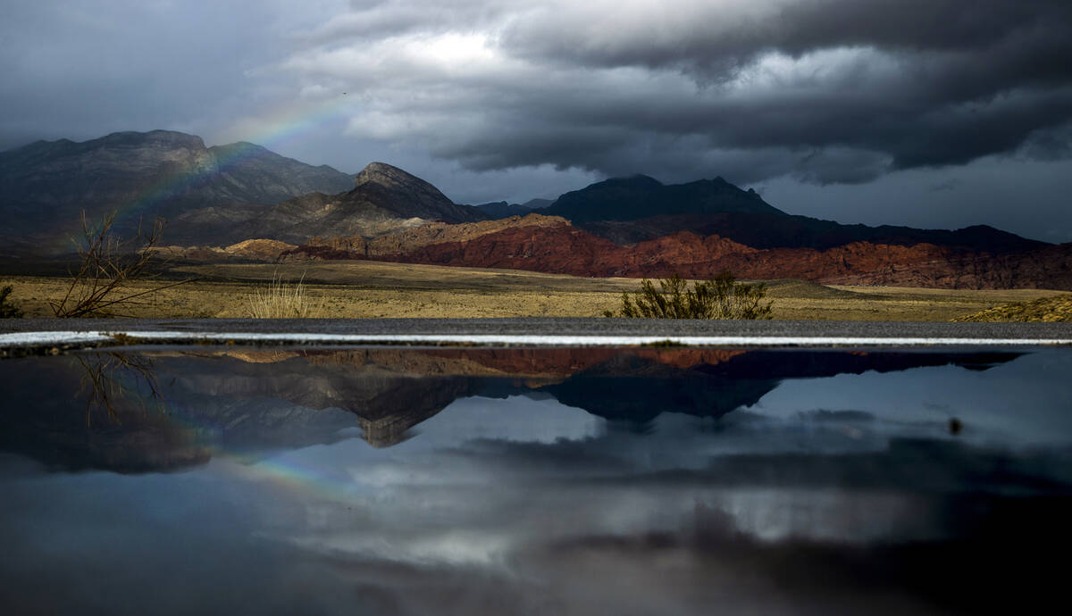 A rainbow appears above the valley floor at the Red Rock Canyon National Conservation Area and ...