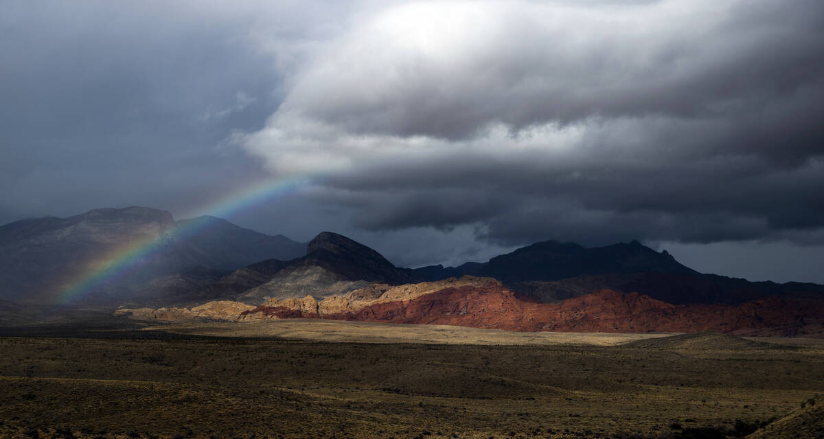 A rainbow appears above the valley floor at the Red Rock Canyon National Conservation Area as r ...