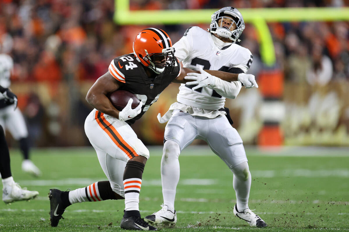 Cleveland Browns running back Nick Chubb (24) stiff arms Raiders safety Johnathan Abram (24) wh ...