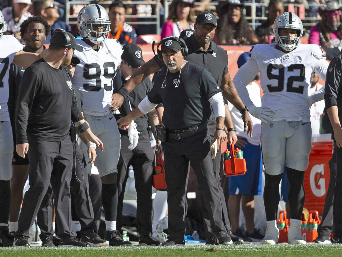Raiders interim head coach Rich Bisaccia directs Raiders defensive end Clelin Ferrell (99) on t ...