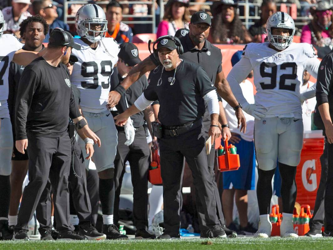 Raiders interim head coach Rich Bisaccia directs Raiders defensive end Clelin Ferrell (99) on t ...