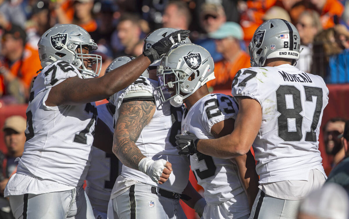 Raiders guard John Simpson (76), Raiders center Andre James (68) and Raiders tight end Foster M ...