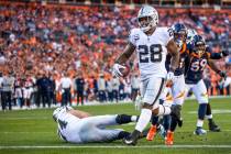 Raiders running back Josh Jacobs (28) eases into the end zone over the Denver Broncos during th ...