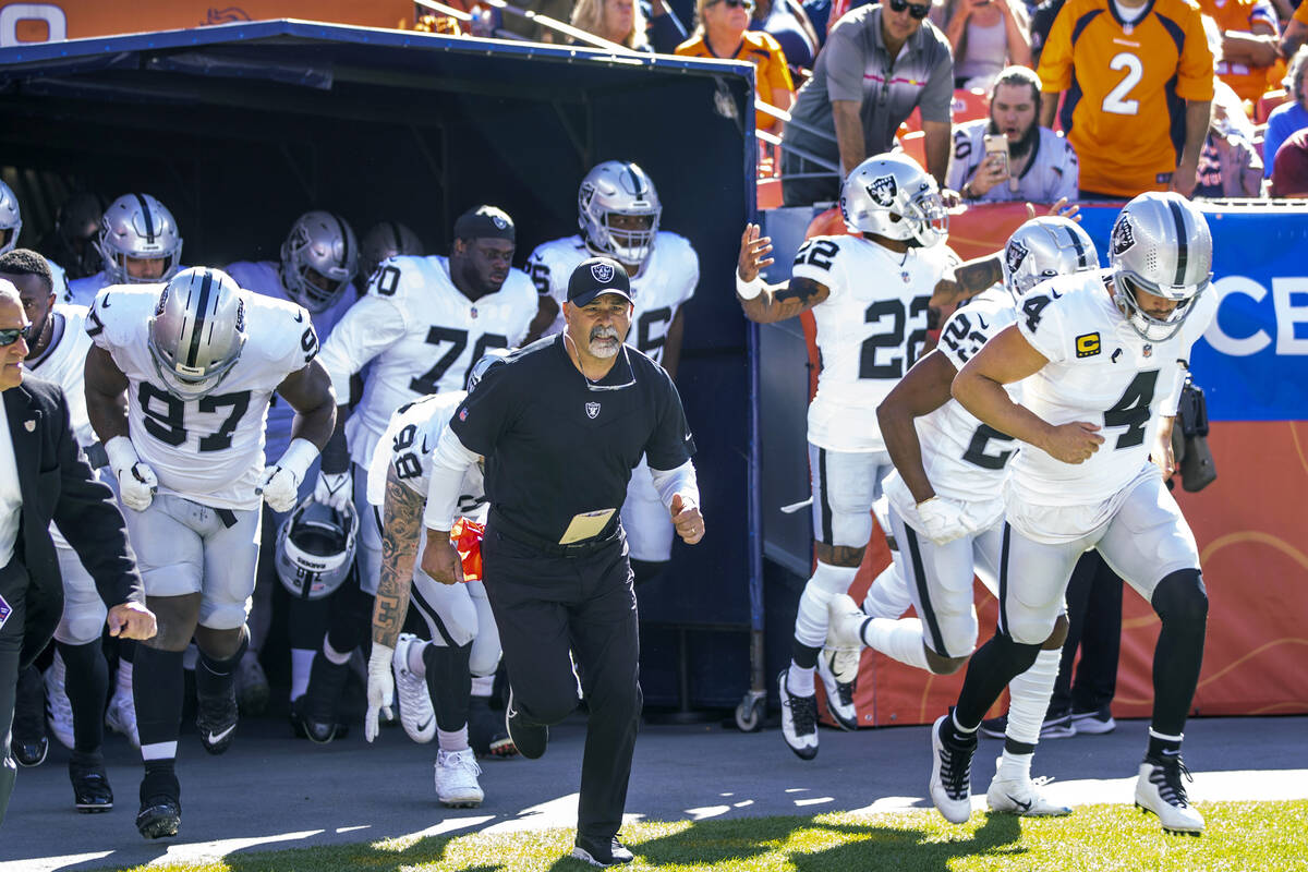 RaidersÕ interim head coach Rich Bisaccia runs onto the field with his players to face the ...