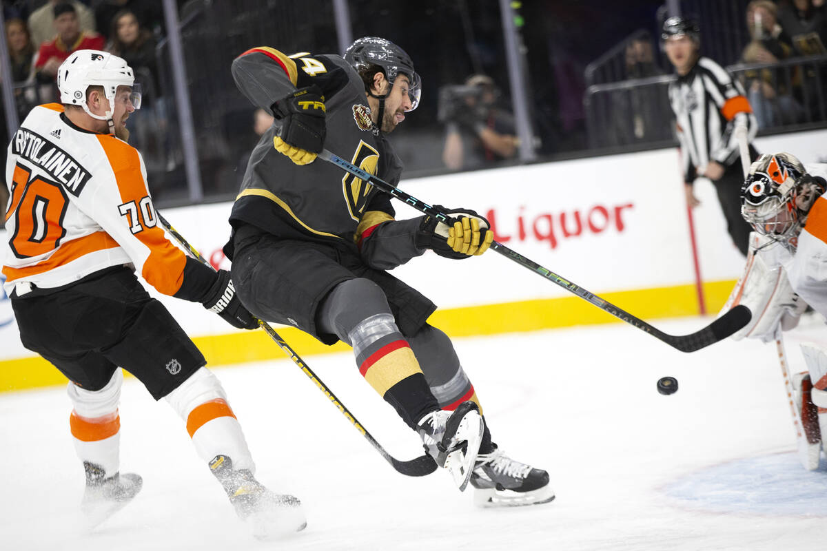 Golden Knights defenseman Nicolas Hague (14) attempts a goal on Flyers goaltender Carter Hart ( ...