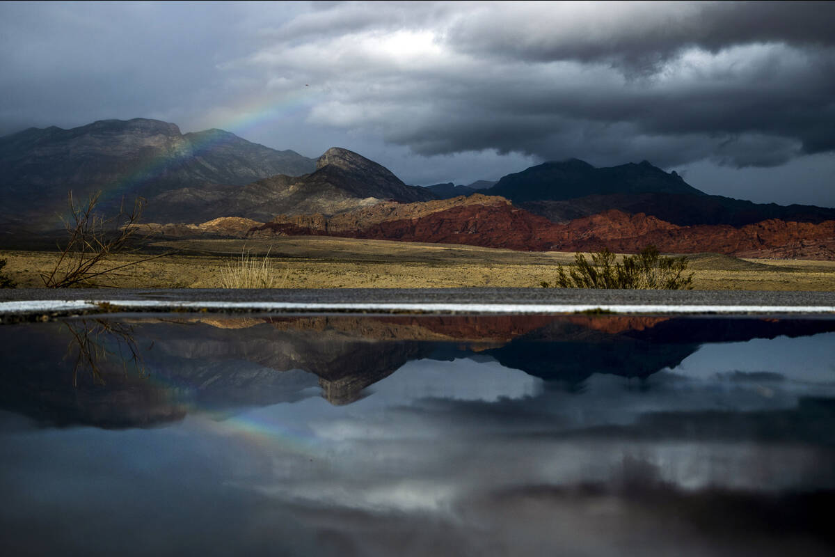 A rainbow appears above the valley floor at the Red Rock Canyon National Conservation Area and ...