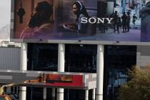 Workers install large size commercial billboard ad of SONY on the Las Vegas Convention Center i ...