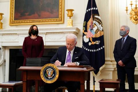 President Joe Biden signs executive orders. (AP Photo/Alex Brandon)