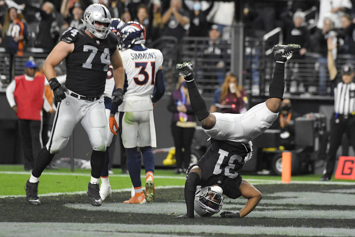 Las Vegas Raiders running back Peyton Barber (31) flips over after scoring a touchdown against ...