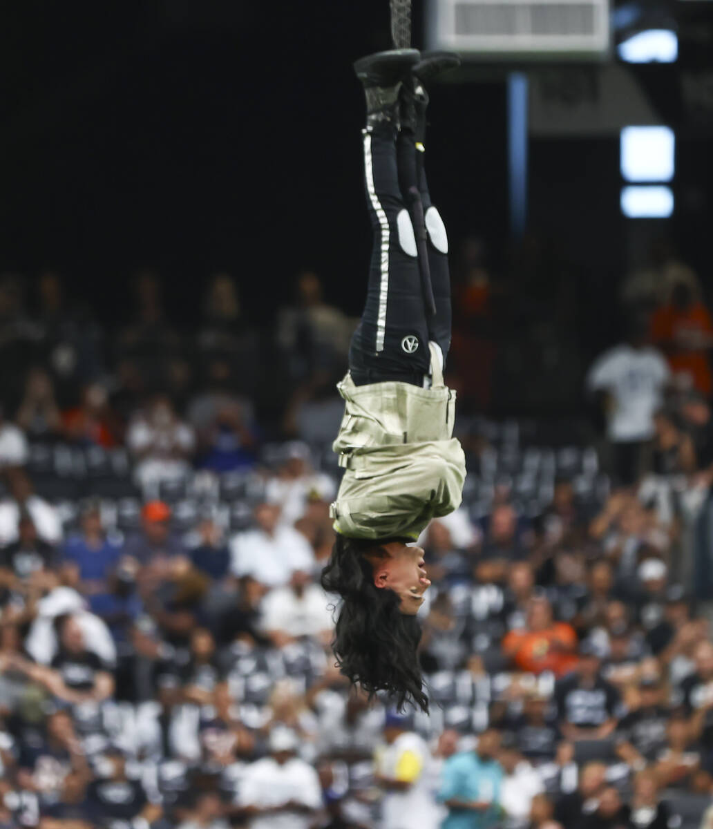 Magician and "Mindfreak" star Criss Angel is raised before dangling over 100 feet in ...