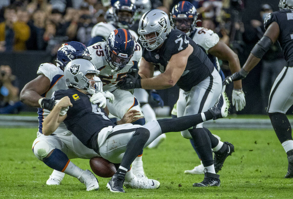 Raiders quarterback Derek Carr (4) fumbles after being stripped and sacked by Denver Broncos de ...