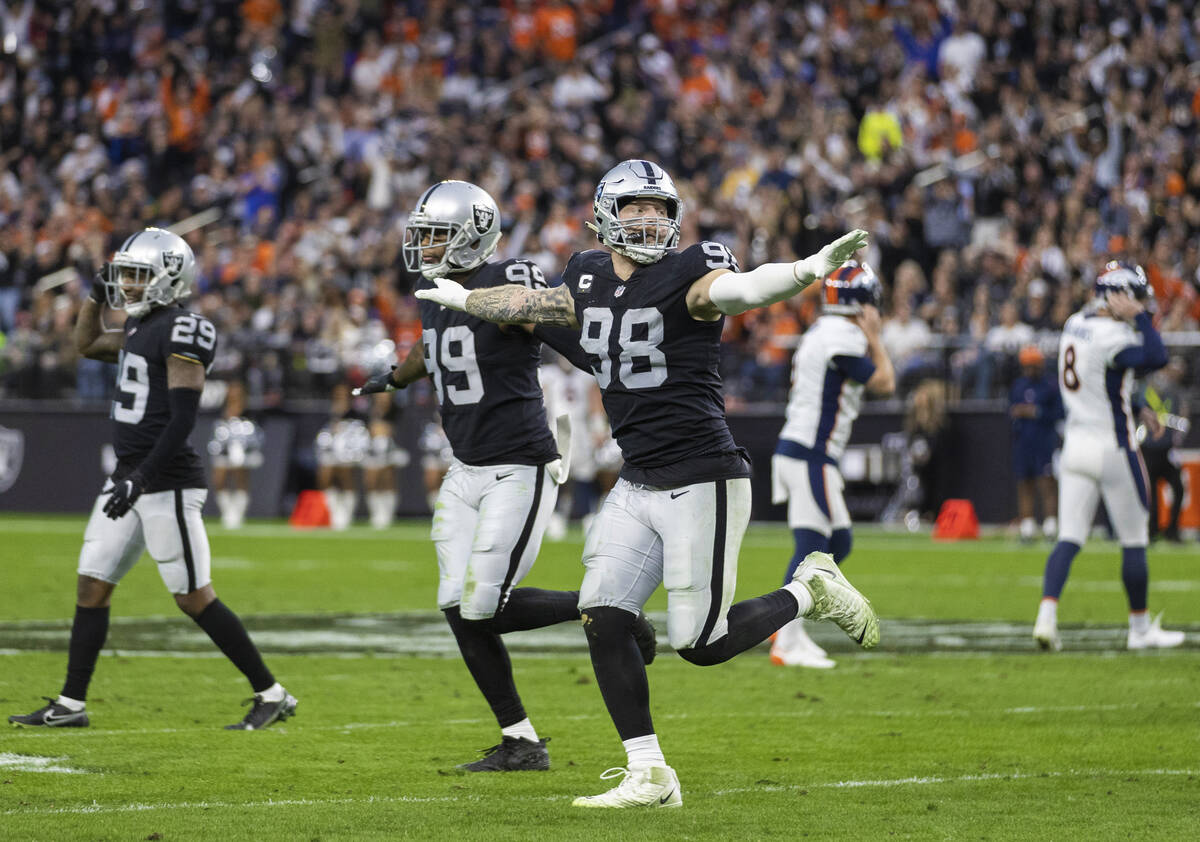 Raiders defensive end Maxx Crosby (98) celebrates a big defensive play with teammates in the se ...