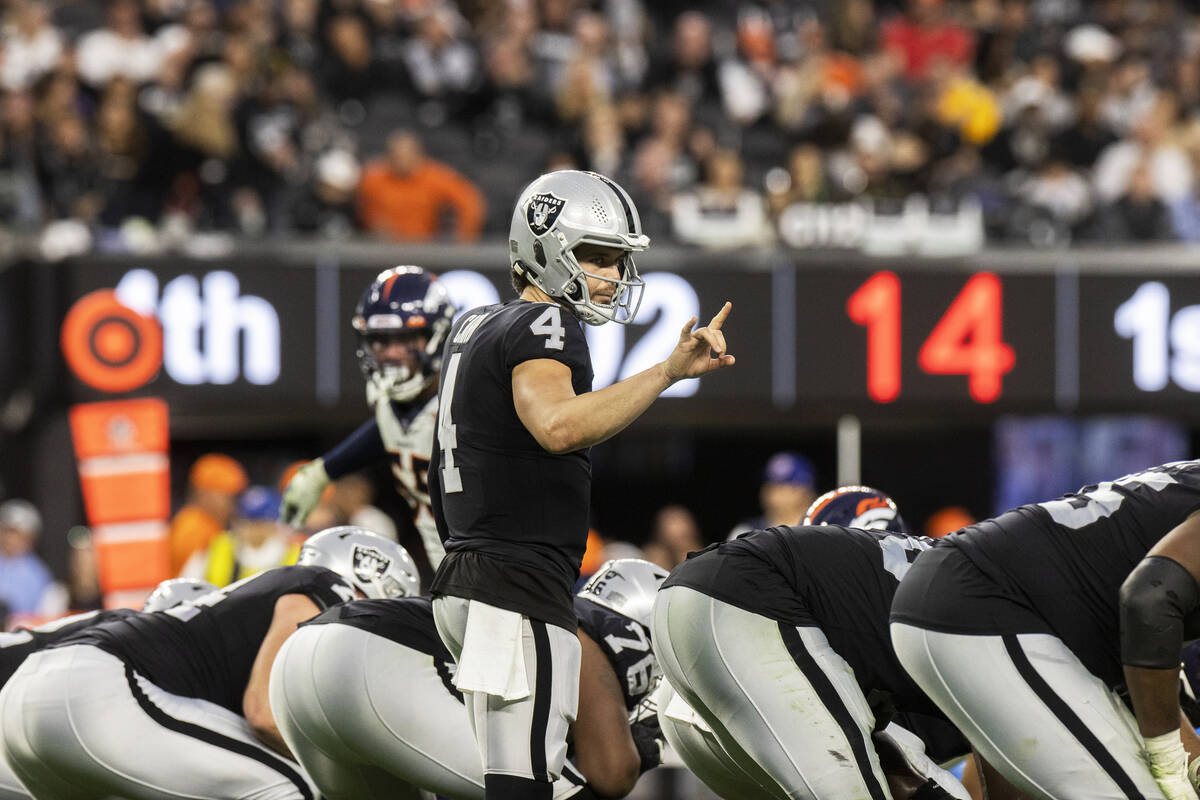 Raiders quarterback Derek Carr (4) audibles at the line in the second half of an NFL football g ...