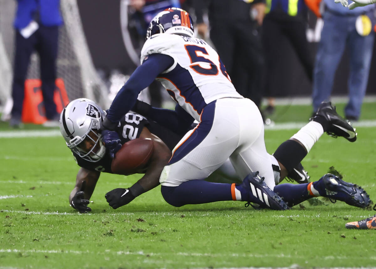 Raiders running back Josh Jacobs (28) tries to recover his fumble against Denver Broncos inside ...
