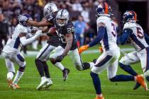 Raiders running back Josh Jacobs (28) catches some air after breaking free for a long run versu ...