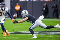 Raiders wide receiver Hunter Renfrow (13) extends for a catch as Denver Broncos free safety Jus ...